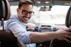 smiling businessman in car