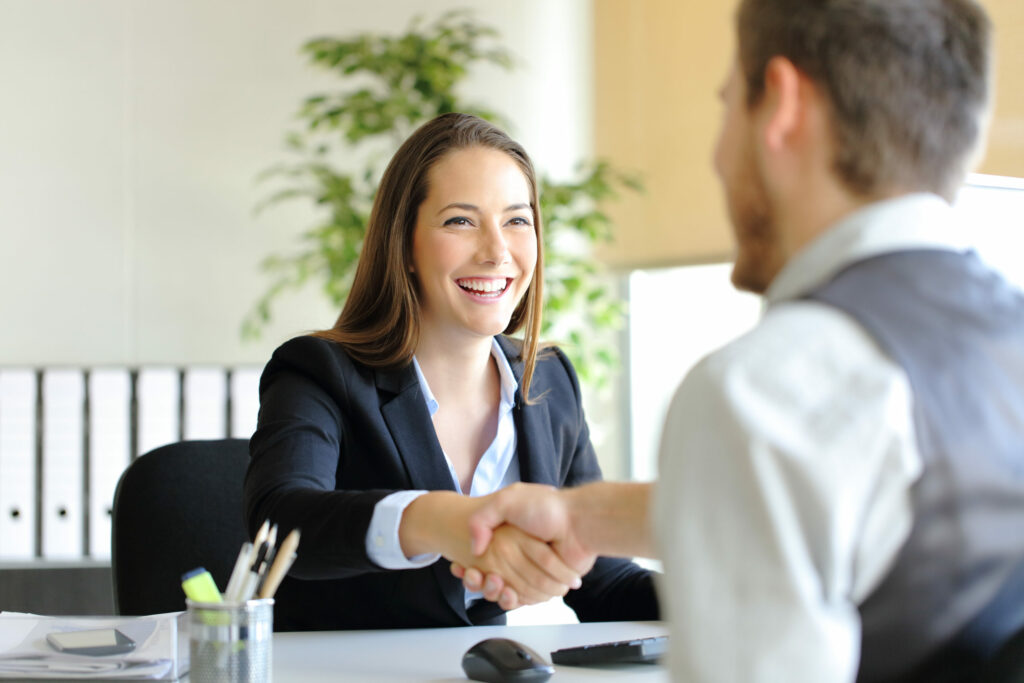 woman and man shaking hands, business loan documents concept