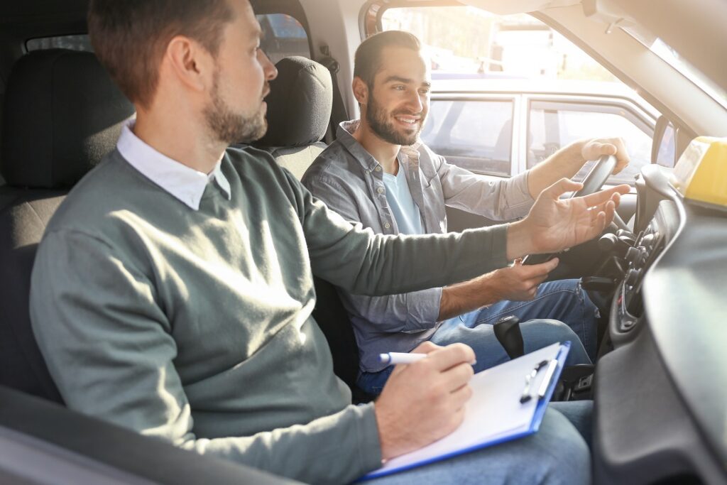 Driving instructor with learner in car